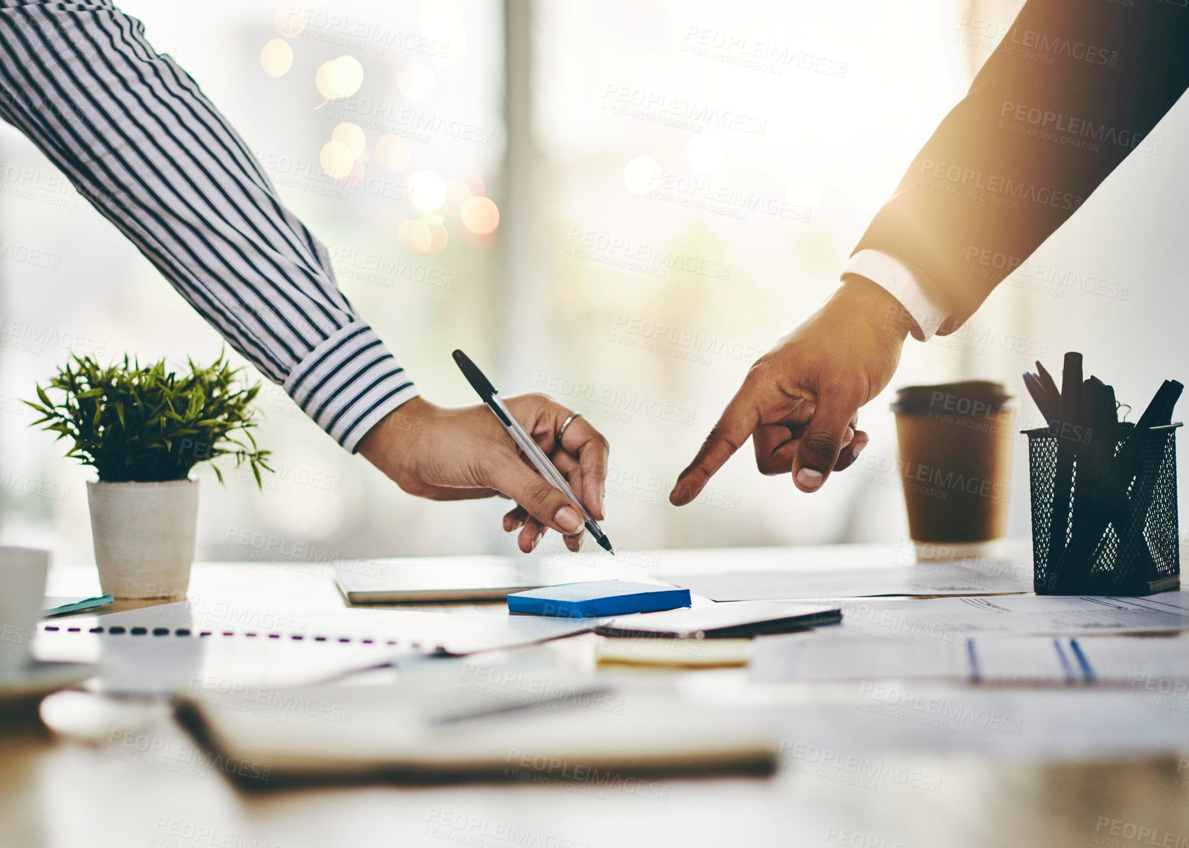 Buy stock photo Closeup shot of two businesspeople going through paperwork in an office