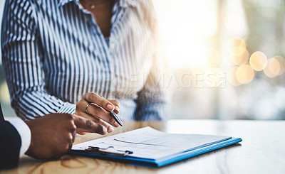 Buy stock photo Closeup shot of two businesspeople going through paperwork in an office