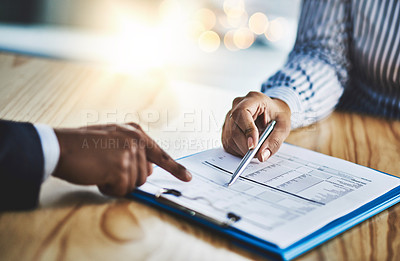 Buy stock photo Closeup shot of two businesspeople going through paperwork in an office