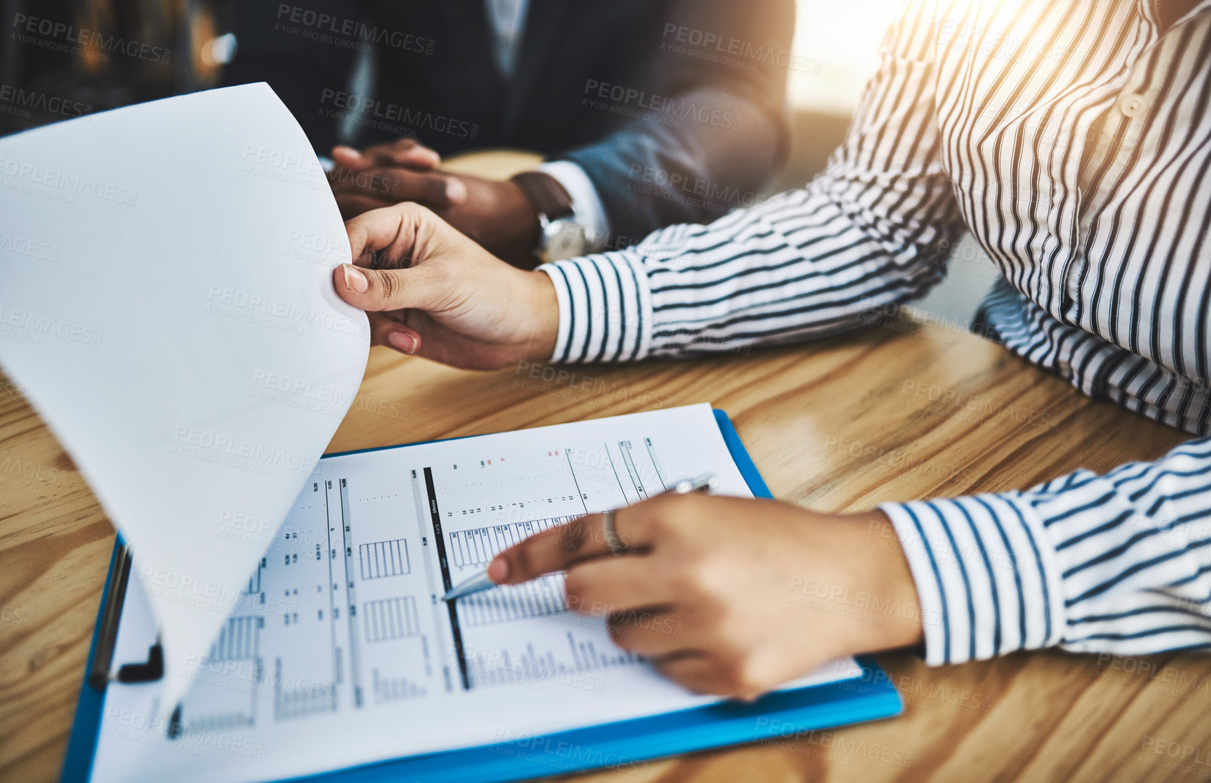 Buy stock photo Closeup shot of two businesspeople going through paperwork in an office