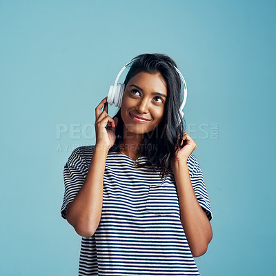 Buy stock photo Music, young Indian woman with headphones and smile in studio background. Technology or entertainment, sound track and happy female person listen to radio or audio podcast isolated in backdrop
