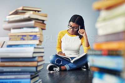 Buy stock photo Shot of a young female student studying at home