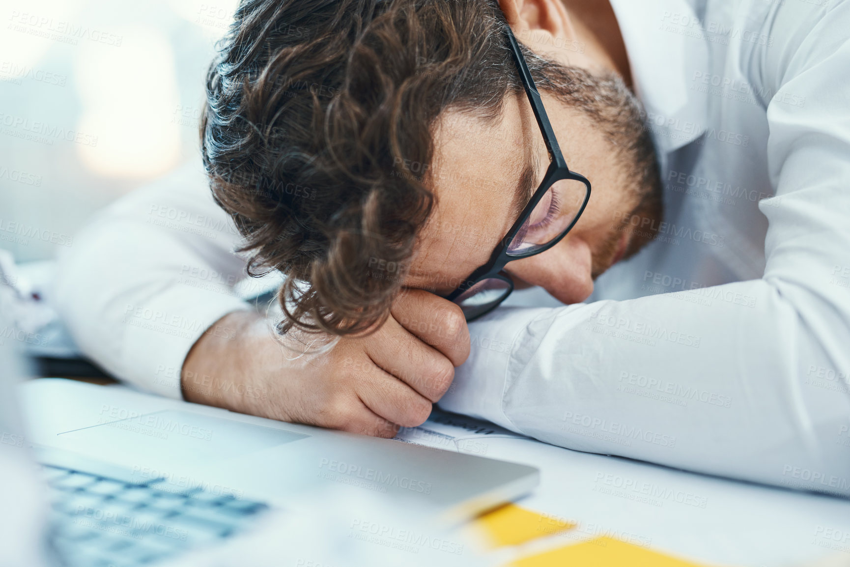 Buy stock photo Overworked, tired and man sleeping on desk with burnout, fatigue and business employee with glasses, papers and laptop sleep in office. Businessman, lawyer and exhausted in company workplace