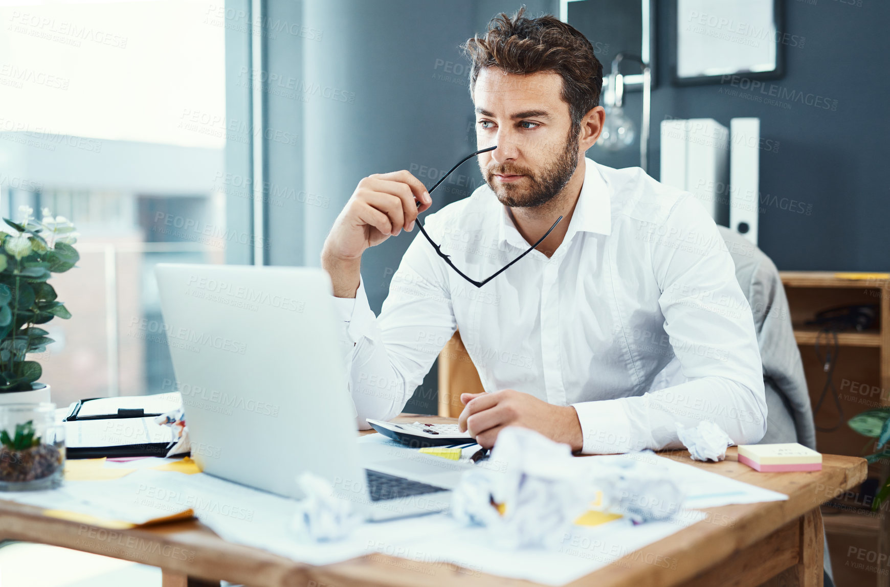 Buy stock photo Business man, laptop and thinking with mess, mistake and problem solving for solution at insurance agency. Person, computer and stress at office, crisis and documents with chaos for audit at company