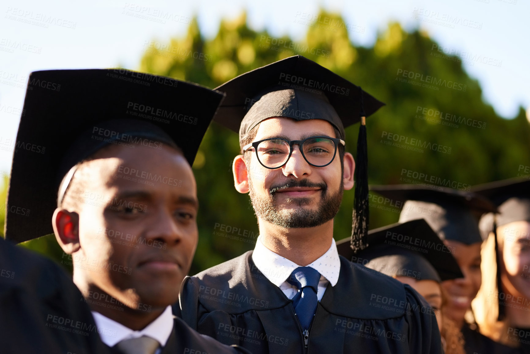 Buy stock photo Graduation, achievement or portrait of man with confidence at university for education or success. College, scholarship or proud student with group of people at campus with degree, smile or diploma