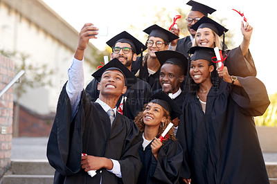 Buy stock photo Shot of a group of students taking selfies on graduation day
