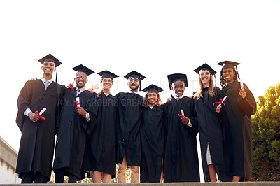 Buy stock photo Portrait of a group of university students standing together on graduation day