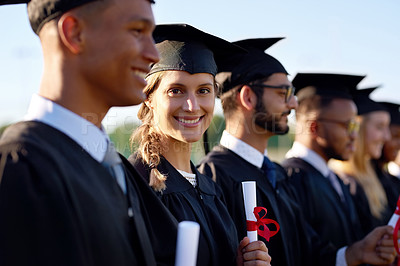 Buy stock photo Portrait of a university student standing amongst her classmates on graduation day