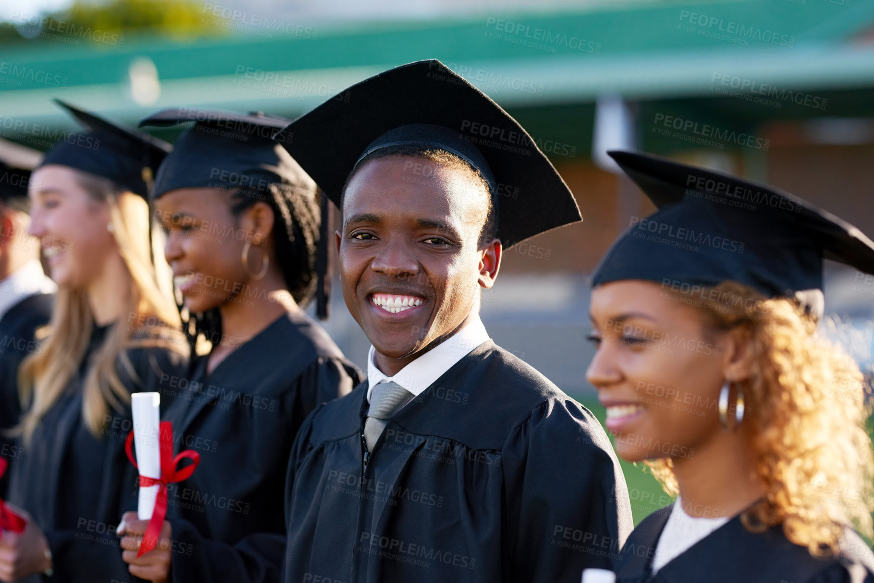 Buy stock photo Happy black man, scholar portrait and graduation class with group at ceremony for education, qualification or future. Person and student with smile for diploma, certificate or degree on campus