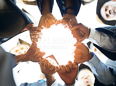 Buy stock photo Closeup shot of a group of students joining their hands together on graduation day