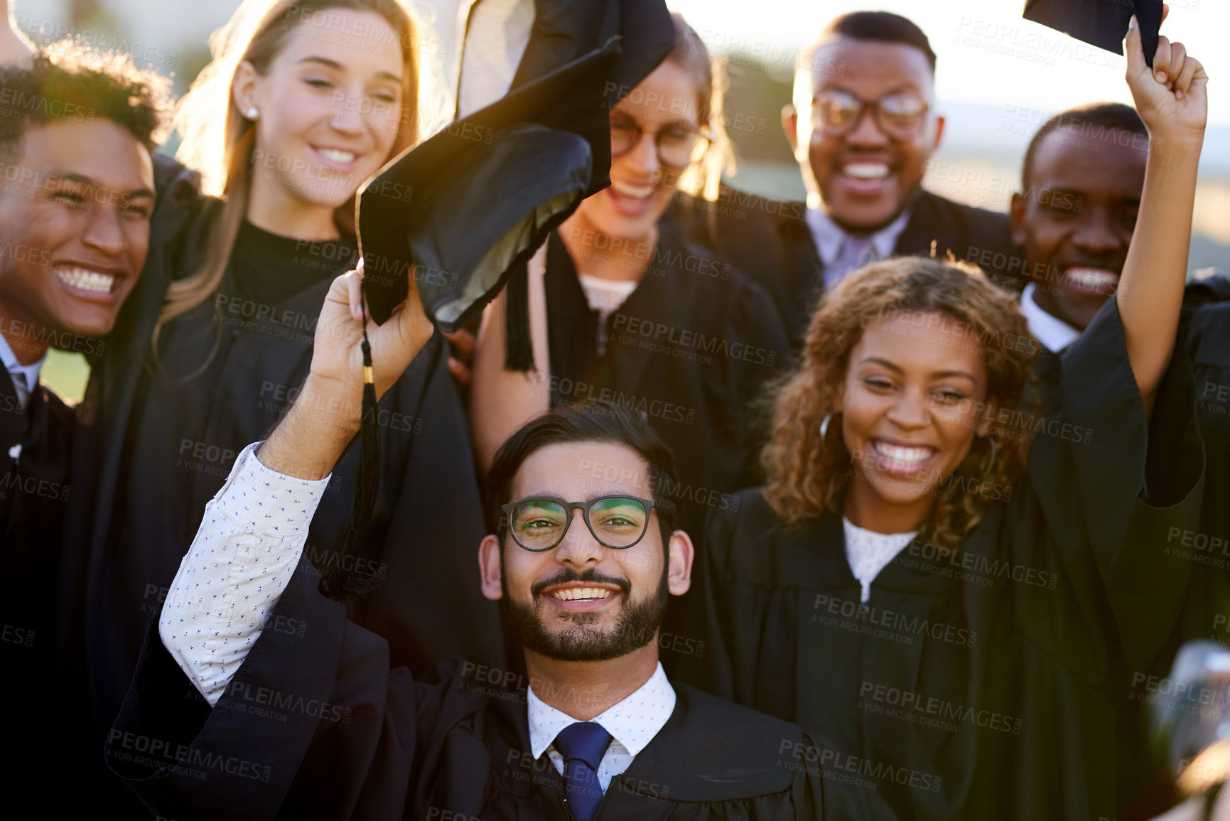 Buy stock photo University, graduation and portrait of people with smile for education, achievement and success. Happy, students and friends with celebration at campus field for qualification, learning and knowledge