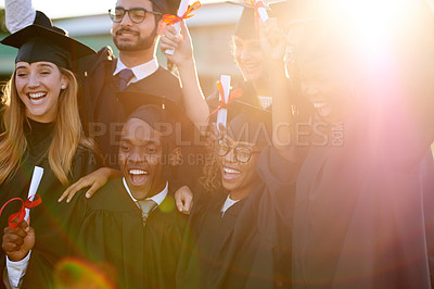 Buy stock photo Shot of a group of university students celebrating their graduation