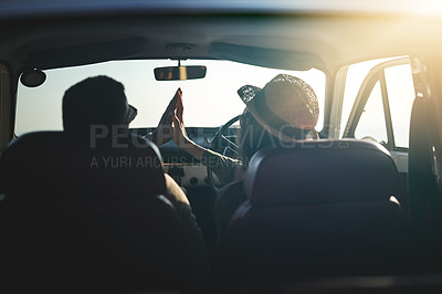 Buy stock photo Rearview shot of a young couple on a road trip