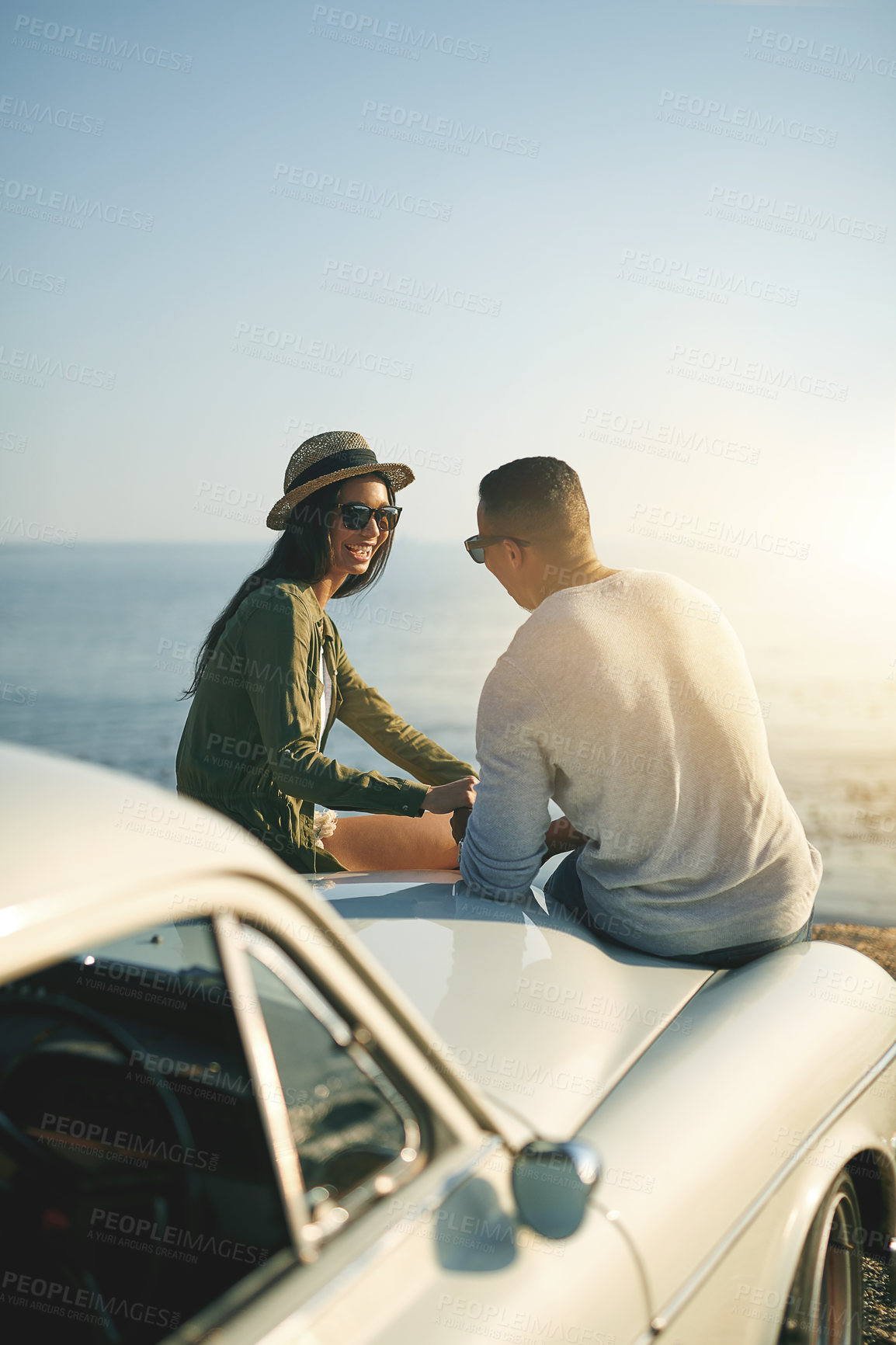 Buy stock photo Relax, road trip and smile with couple at ocean together for holiday, travel or vacation in nature. Bonding, conversation or love happy man and woman outdoor for anniversary, honeymoon or romance