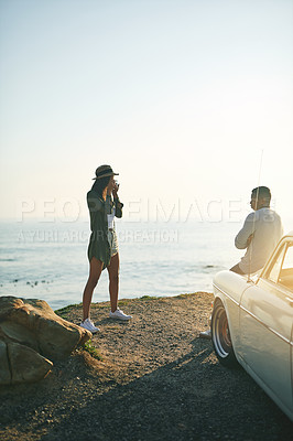 Buy stock photo Shot of a young couple making a stop at the beach while out on a roadtrip