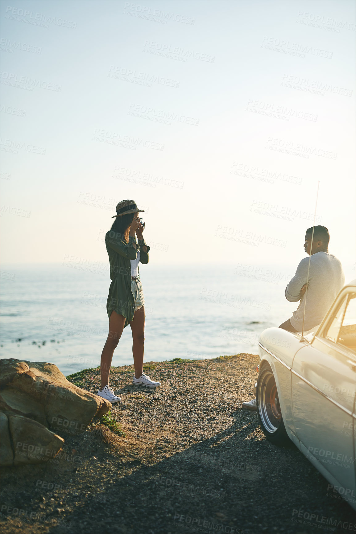Buy stock photo Photograph, road trip and sunset with couple at ocean together for holiday, travel or vacation in nature. Adventure, bonding or memory with man and woman outdoor for anniversary, honeymoon or romance
