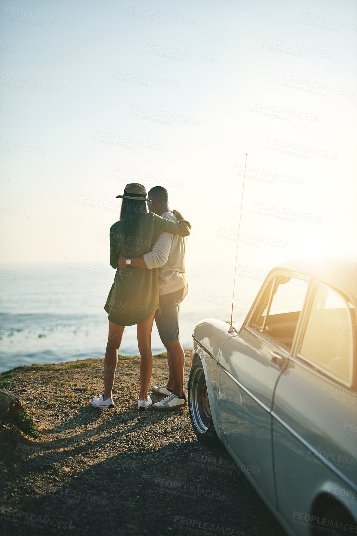 Buy stock photo Back, hug and road trip with couple by sea together for holiday, travel or vacation in nature. Adventure, bonding or love with man and woman embracing at ocean for anniversary, honeymoon or romance