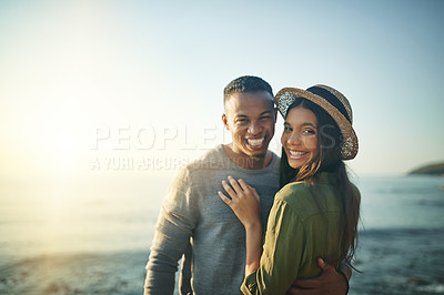 Buy stock photo Shot of a young couple on the beach at sunset