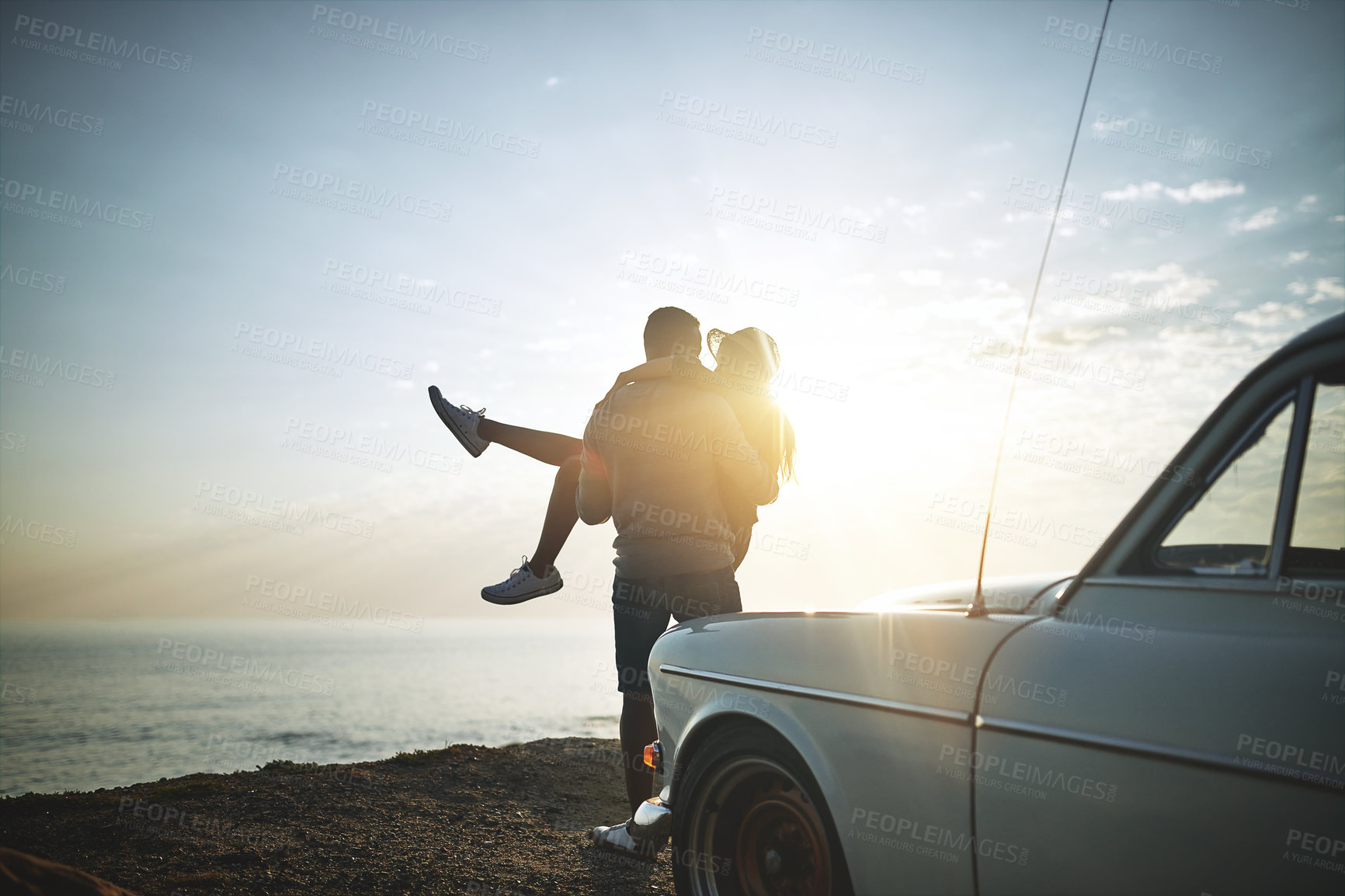 Buy stock photo Back, carry and road trip with couple at ocean together for holiday, travel or vacation in nature. Adventure, lifting or love with man and woman bonding outdoor for anniversary, honeymoon or romance