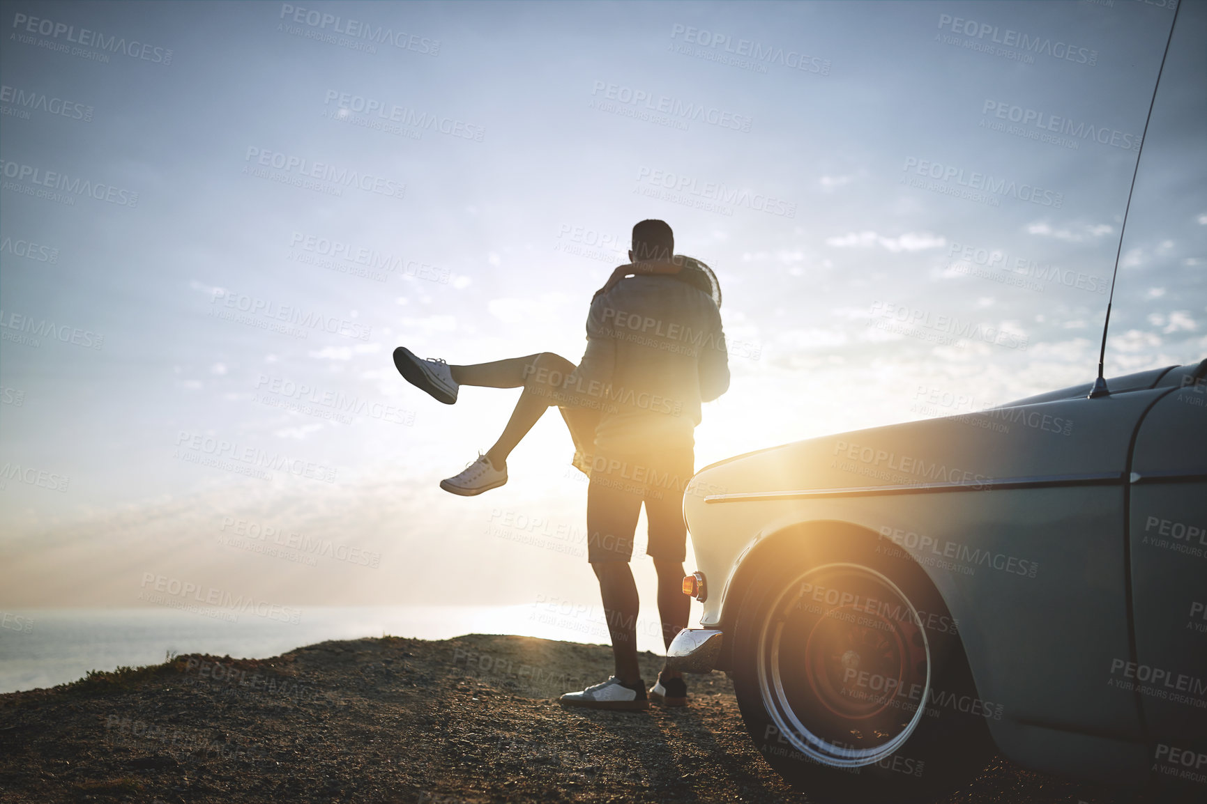 Buy stock photo Back, lifting and road trip with couple at ocean together for holiday, travel or vacation in nature. Adventure, bonding or carry with man and woman outdoor for anniversary, honeymoon or romance