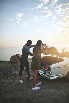 Buy stock photo Shot of a young couple making a stop at the beach while out on a road trip