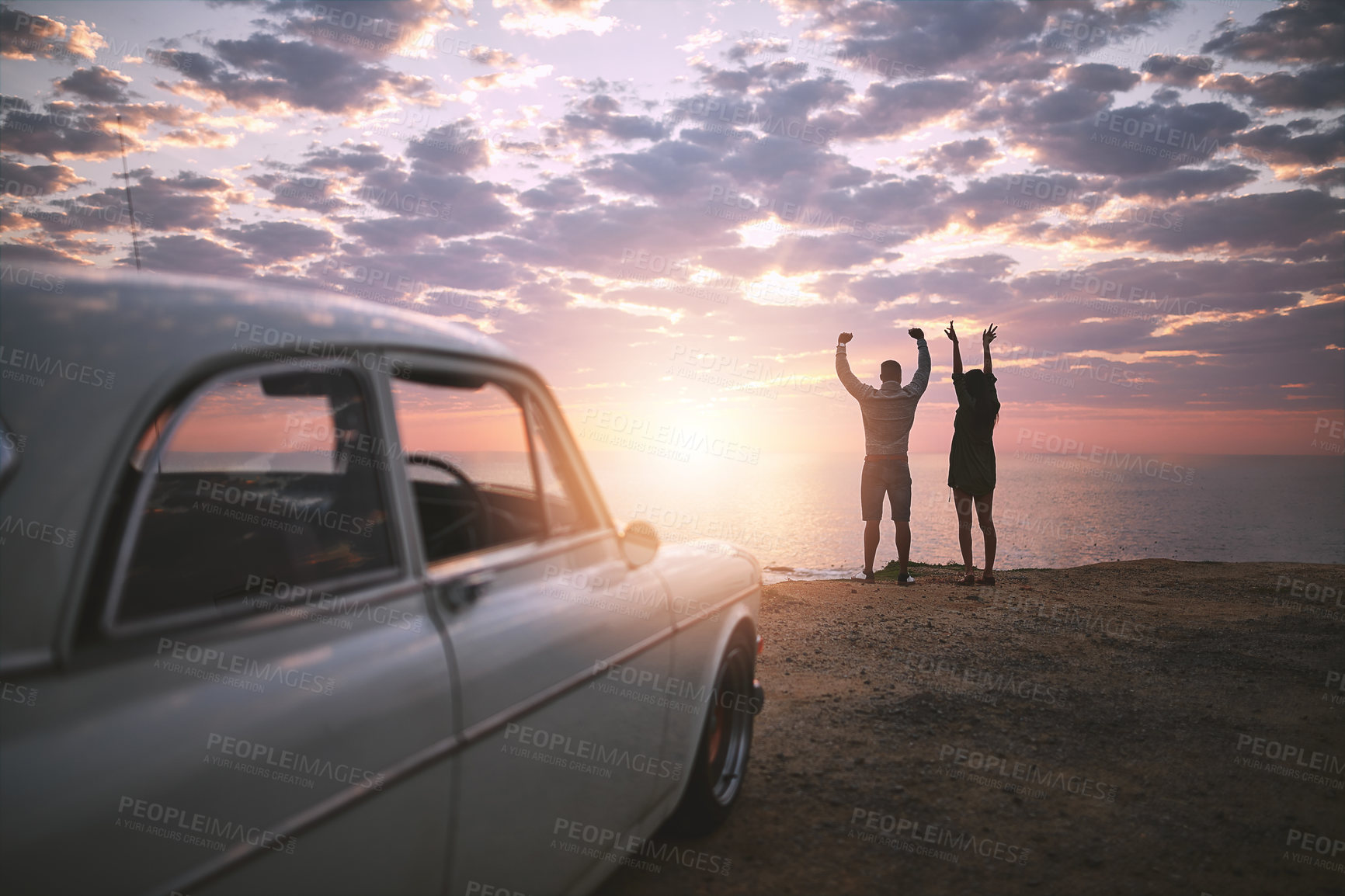 Buy stock photo Celebration, hands raised and road trip with couple at ocean together for holiday, travel or vacation in nature. Back, motivation or winner with man and woman outdoor for cheering, success or victory