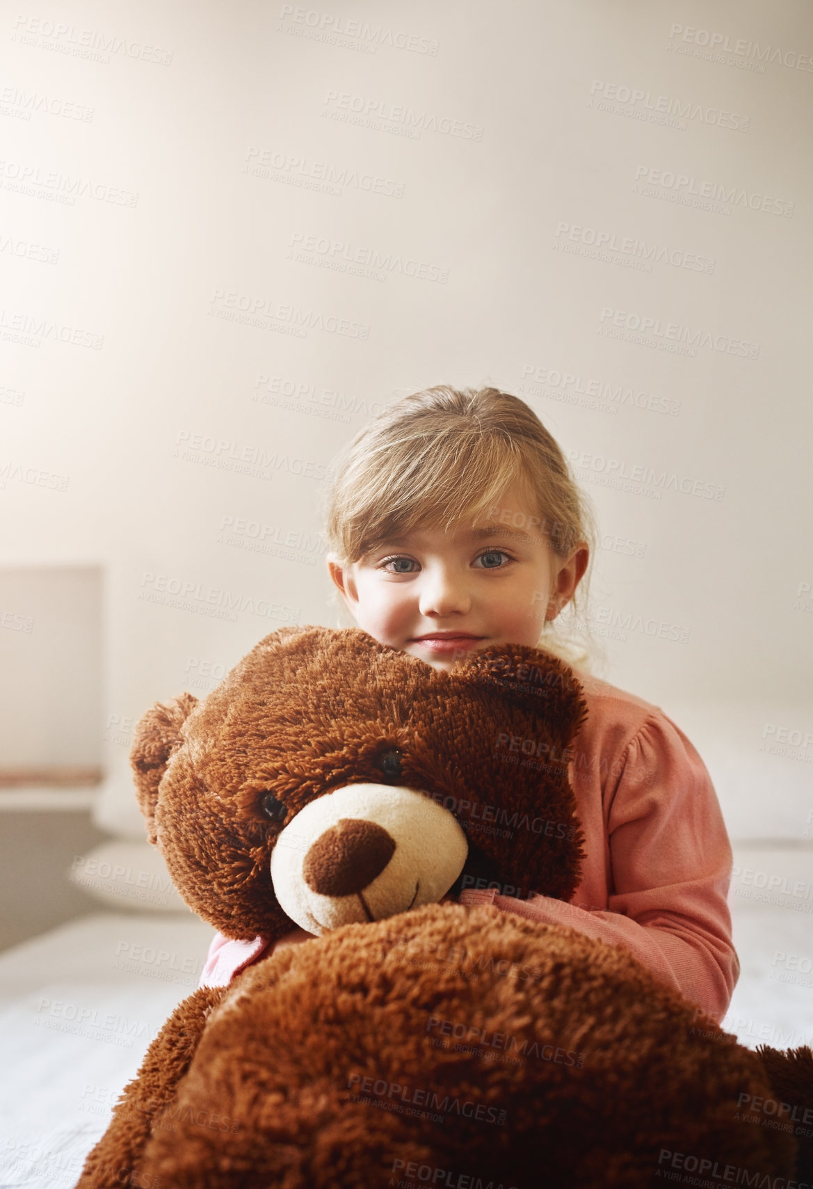 Buy stock photo Little girl, portrait and bed with teddy bear for cuddle, childhood or comfort at home. Young child, female person or kid with smile or hug for stuffed animal, friendship or care in bedroom at house