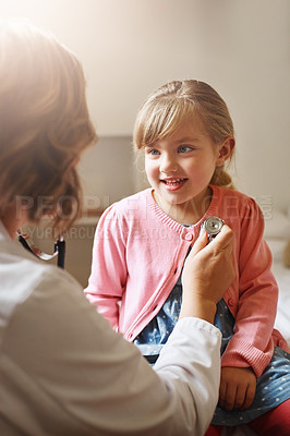Buy stock photo Shot of a doctor examining a little girl with a stethoscope in her consulting room