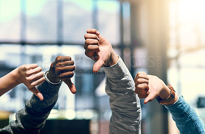 Buy stock photo Cropped shot of a group of unrecognizable businesspeople gesturing thumbs down