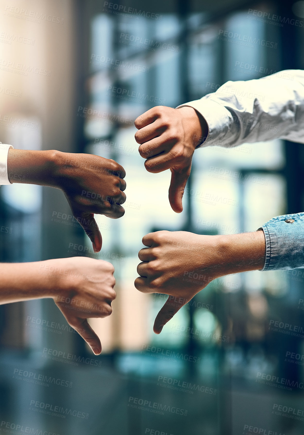 Buy stock photo Cropped shot of a group of unrecognizable businesspeople gesturing thumbs down