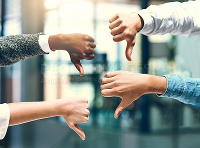 Buy stock photo Cropped shot of a group of unrecognizable businesspeople gesturing thumbs down