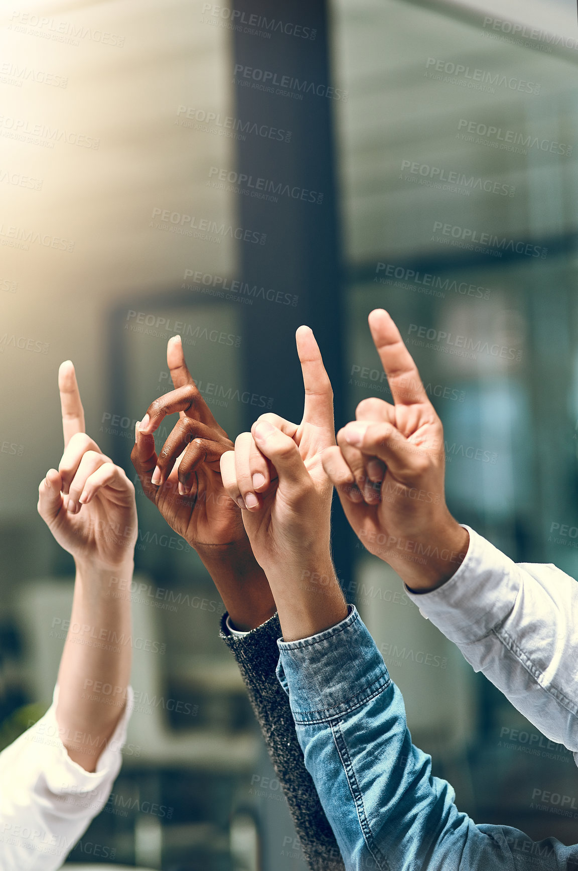 Buy stock photo Cropped shot of a group of unrecognizable businesspeople pointing upwards