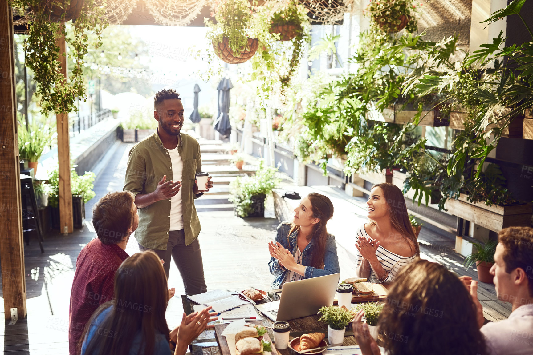 Buy stock photo Applause, restaurant and black man with business people in meeting for lunch discussion, planning and success. Cafe, teamwork and men and women clapping for winning, collaboration and achievement