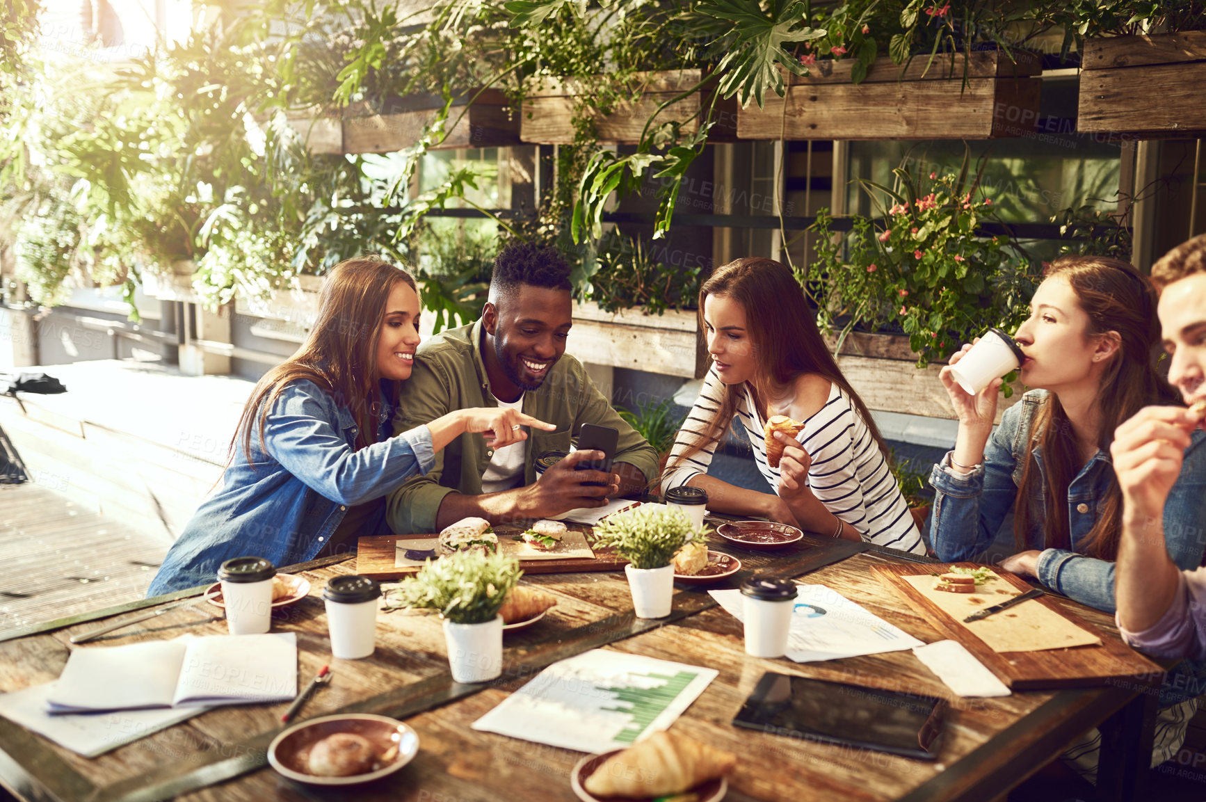 Buy stock photo Teamwork, restaurant and business people in meeting with phone for internet, social networking and website. Coffee shop, lunch and men and women chatting for discussion, planning and strategy