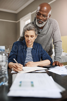 Buy stock photo Shot of a senior couple working on their finances at home