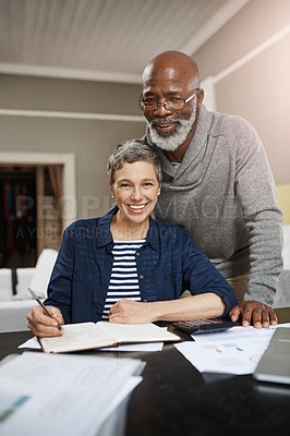 Buy stock photo Portrait of a senior couple working on their finances at home