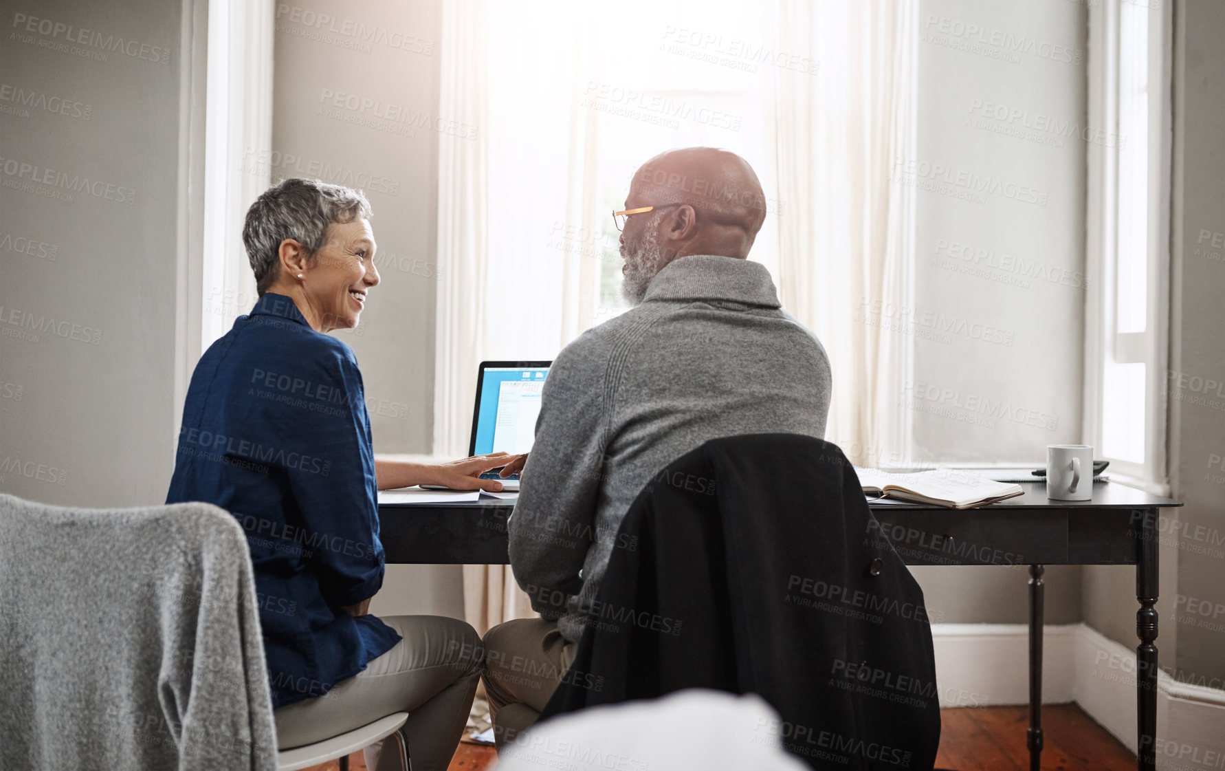 Buy stock photo Shot of a senior couple working on their finances at home
