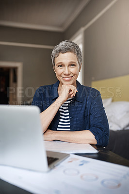 Buy stock photo Shot of a senior woman working on her finances at home