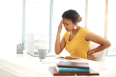 Buy stock photo Shot of a young businesswoman experiencing stress at her desk in a modern office