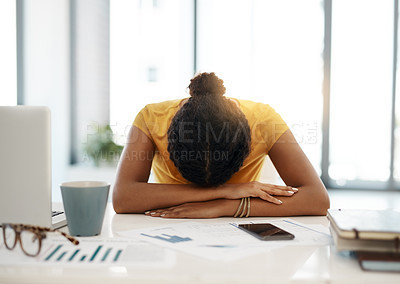 Buy stock photo Shot of a young businesswoman with her head down on her office desk