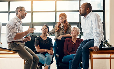 Buy stock photo Shot of a group of businesspeople having a discussion in a modern office