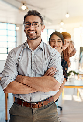 Buy stock photo Portrait of a group of confident businesspeople standing together in a modern office