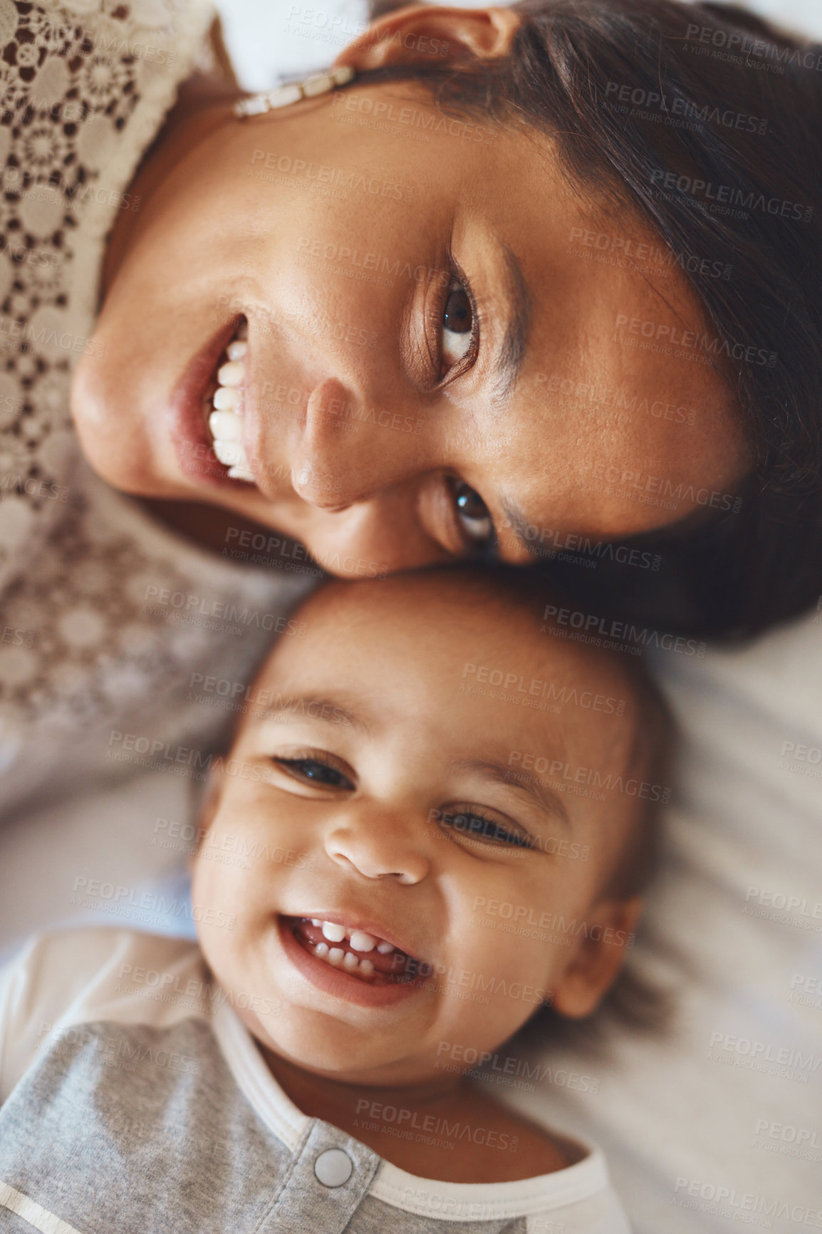 Buy stock photo Cropped shot of a mother and her adorable son lying together