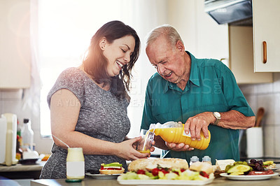 Buy stock photo Cropped shot of a woman and her senior male patient making lunch