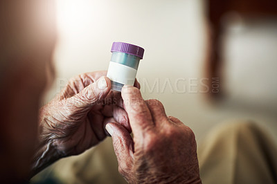 Buy stock photo Senior person, hands and reading prescription with pills for illness, medication or sickness at old age home. Closeup of elderly or chronic patient checking container for medical dose or side effects