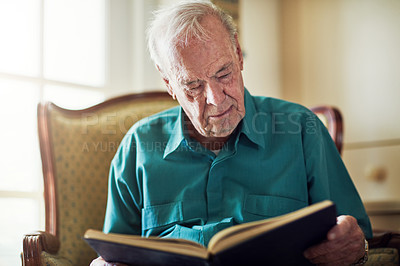 Buy stock photo Elderly man, story and reading book in home, literature and language for learning in retirement. Old person, fiction and textbook for knowledge to relax on couch, novel and studying information