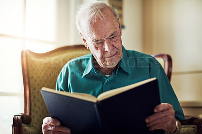 Buy stock photo Elderly man, hobby and reading book in home, literature and language for learning in retirement. Old person, fiction and textbook for knowledge to relax, self improvement and studying information