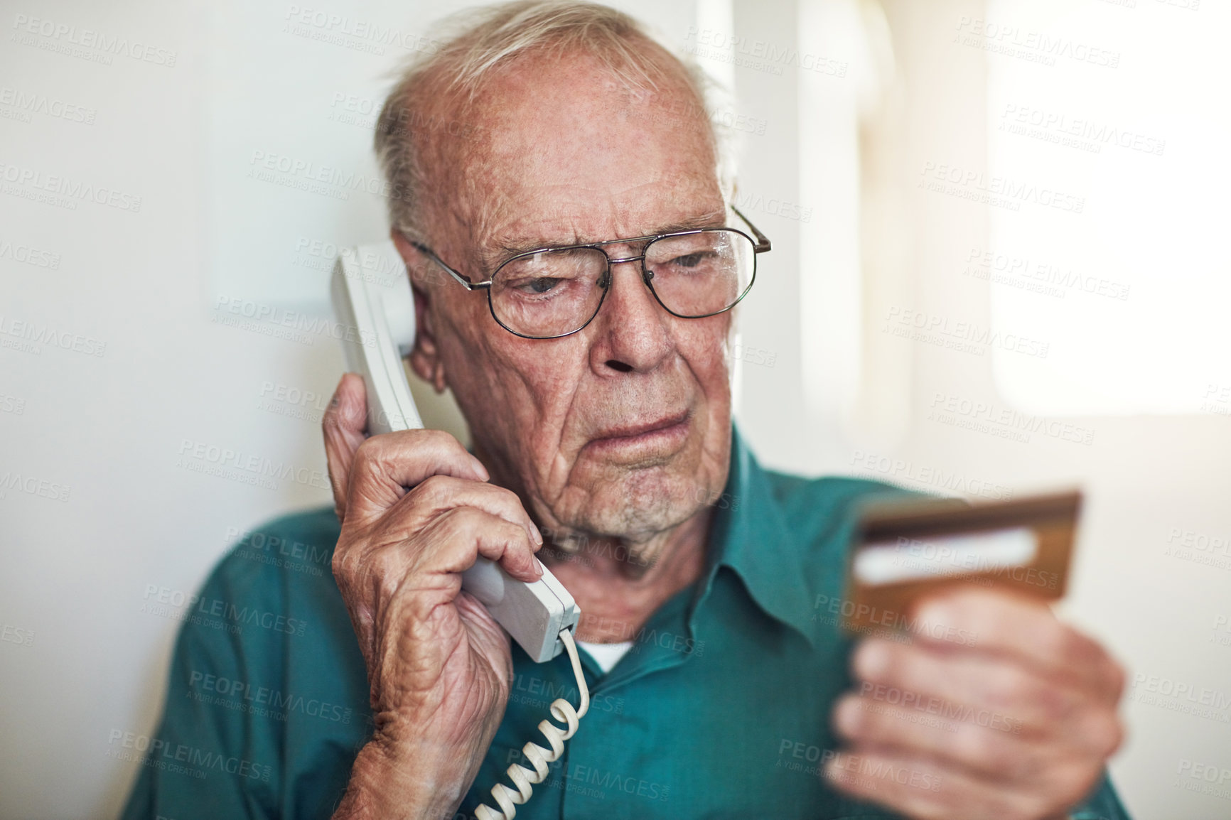 Buy stock photo Senior man, telephone and call with credit card for banking, finance or reading instruction on account at home. Elderly male person talking with debit in financial problem, retirement or pension fund