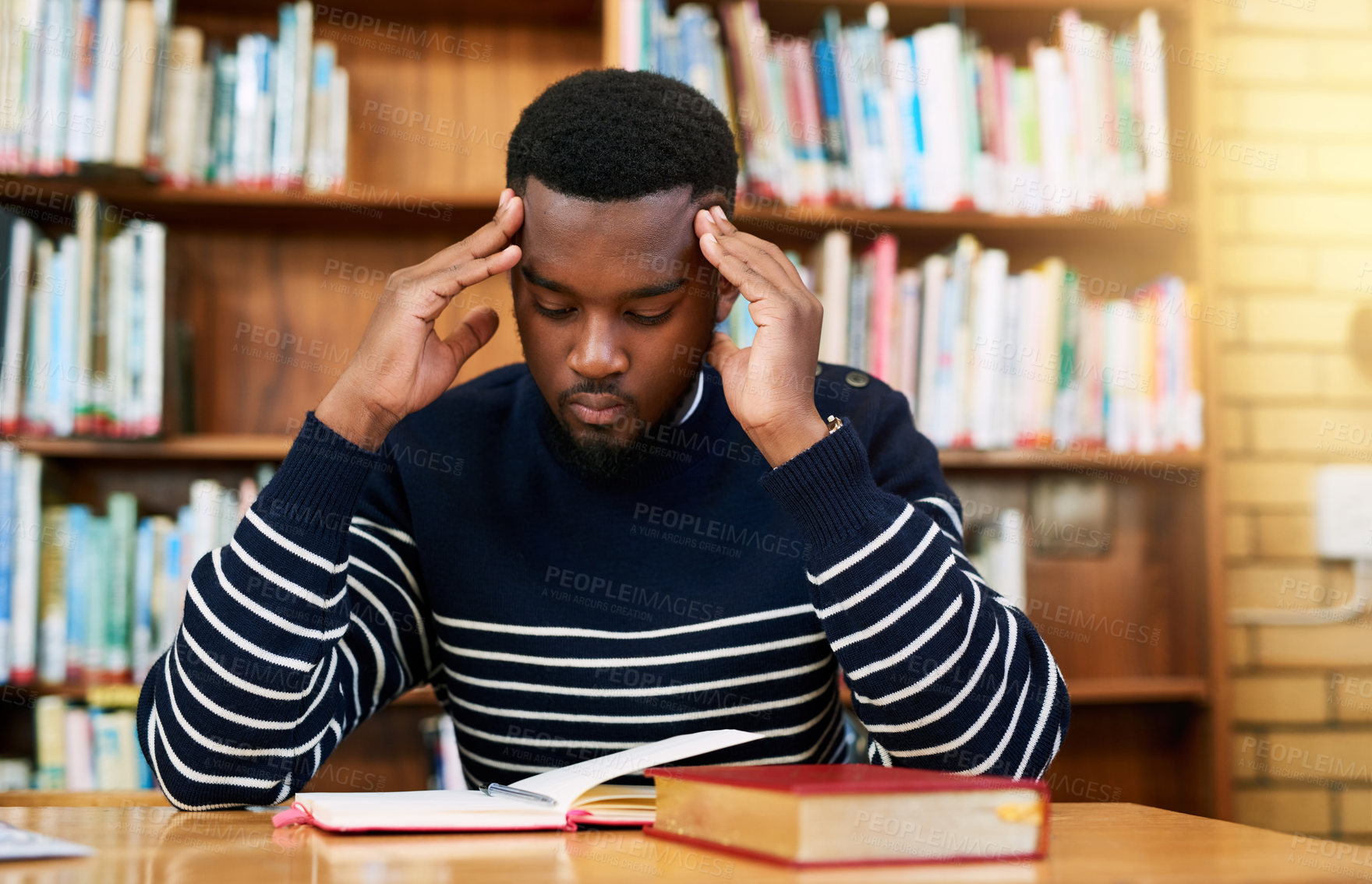 Buy stock photo Stress, studying and black man with books in library for university, fatigue and overtime on research project. Pain, brain fog and tired college student with notes, schedule and deadline headache