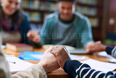 Buy stock photo Students, people or holding hands in prayer in school for blessings, grace or guidance in library. Closeup, friends and hope with spirituality for thanks, college or teamwork in study group for exams